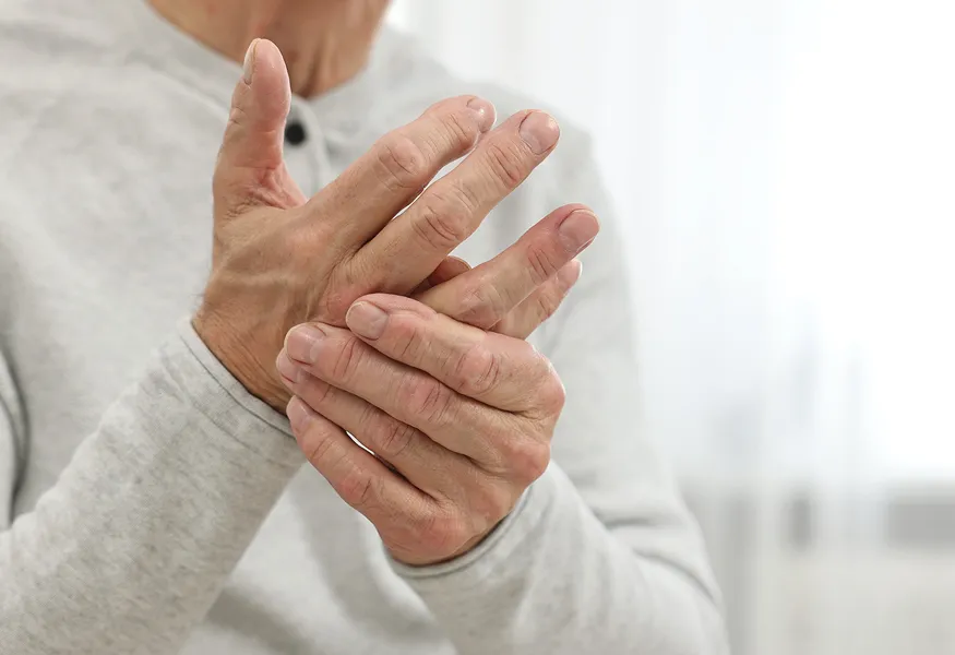 Person holding injured hand